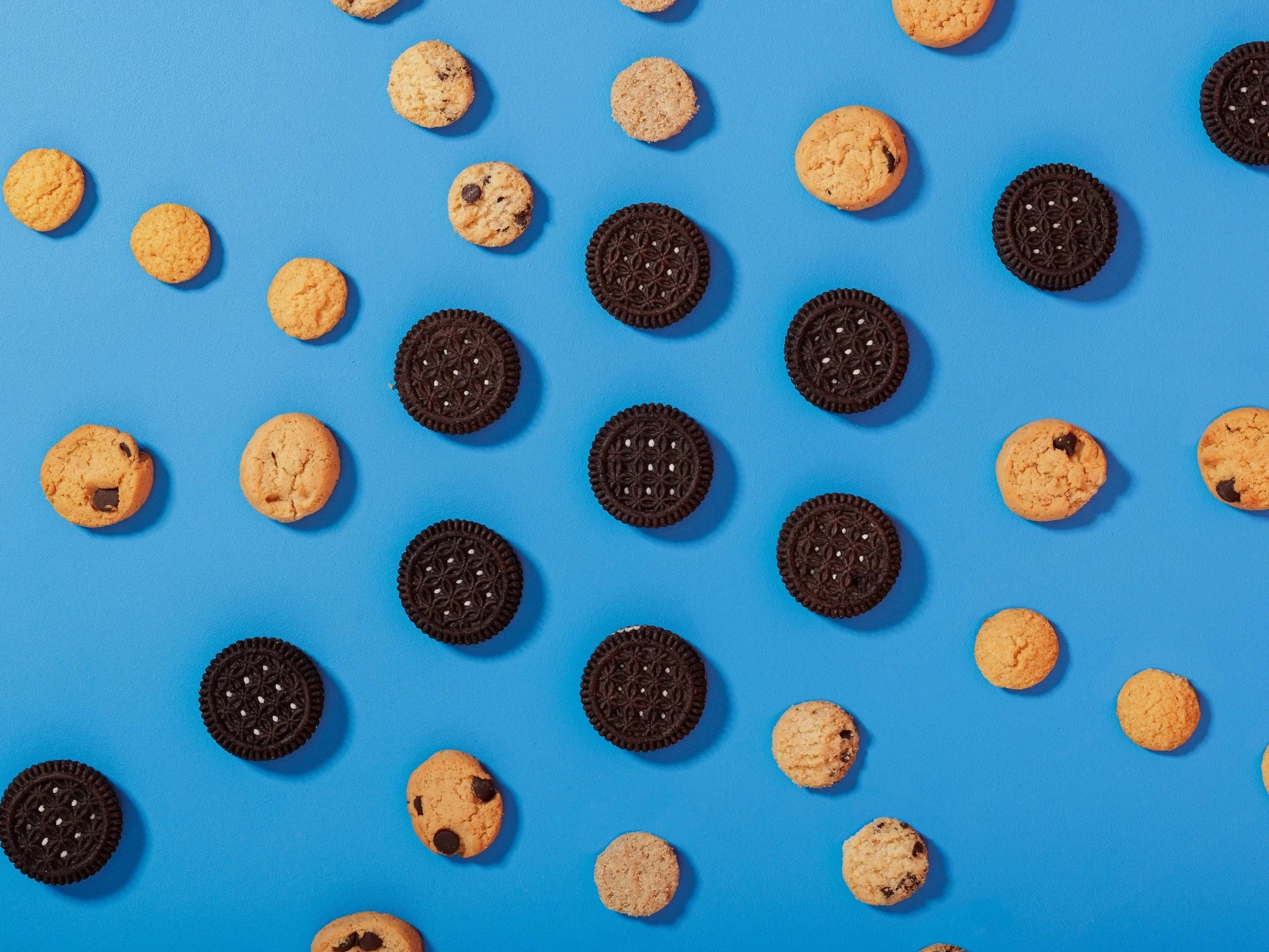 Assortment of highkey gluten free low sugar cookies on a blue background