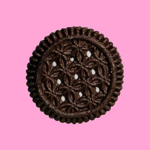 highkey gluten free sugar free chocolate sandwich cookie with vanilla cream on a pink background