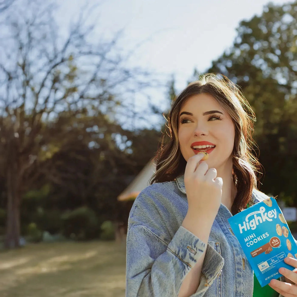 Woman eating highkey low sugar gluten free snickerdoodle cookies